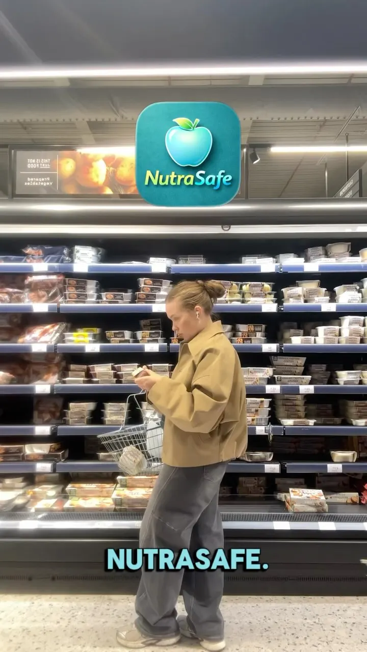 A shopper reading a packet in a supermarket chilled aisle